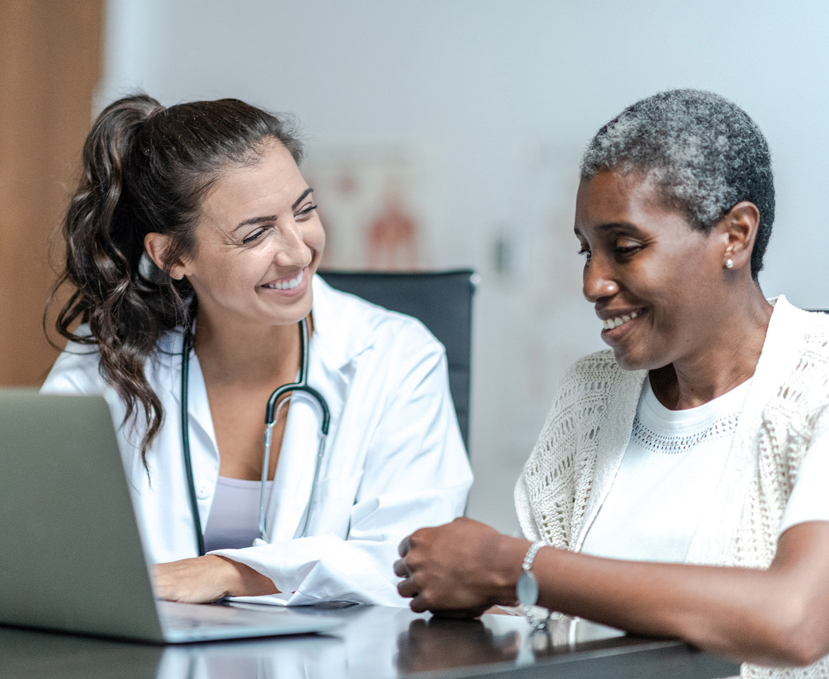 Young Female Doctor with Elderly Patient stock photo