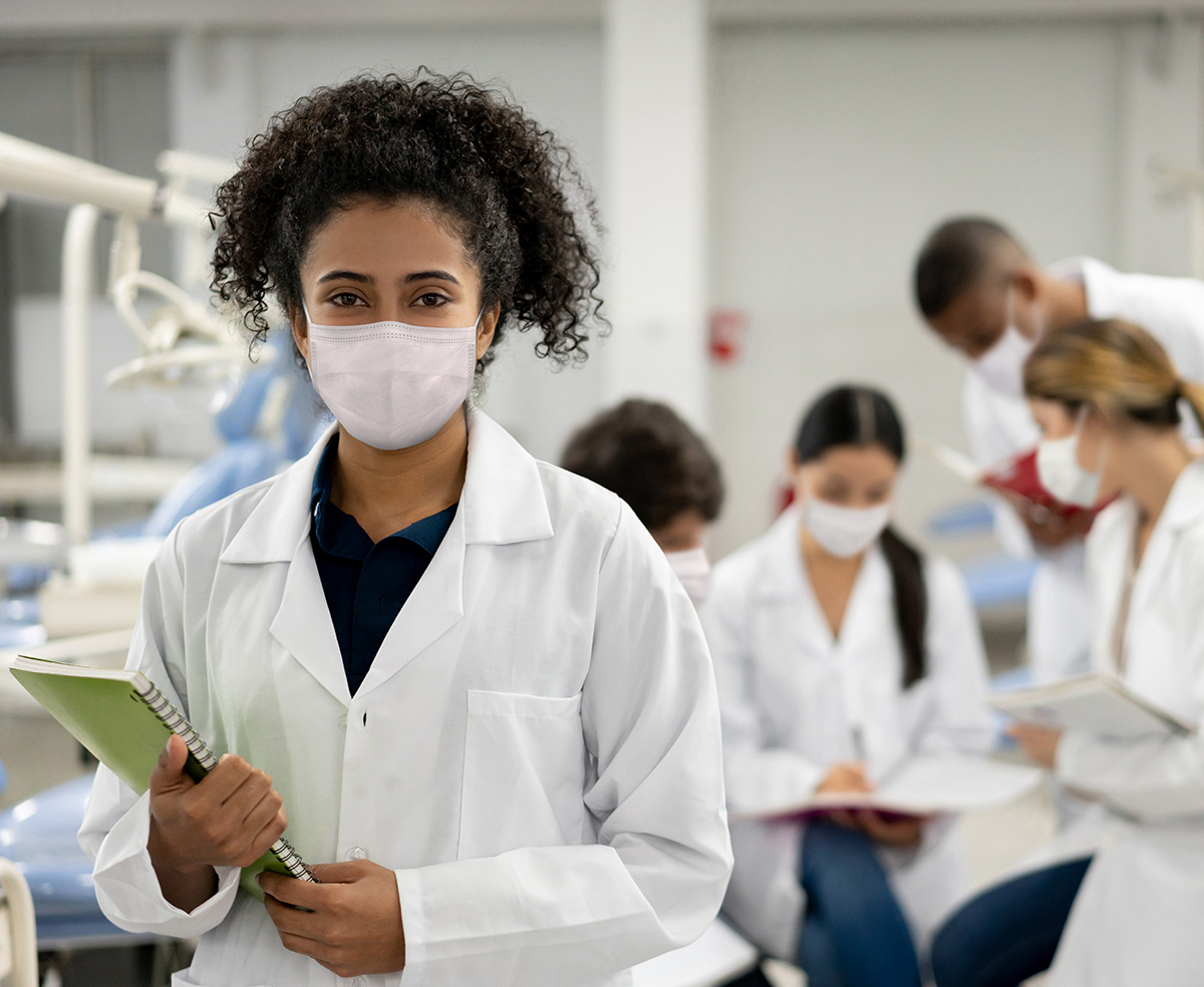 african american female wearing a mask holding a clipboard