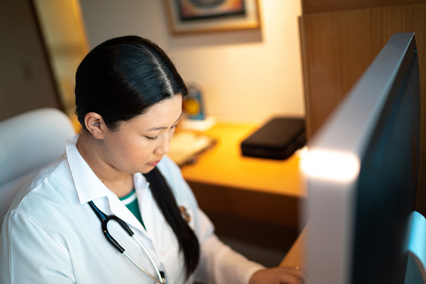 female doctor working at a computer