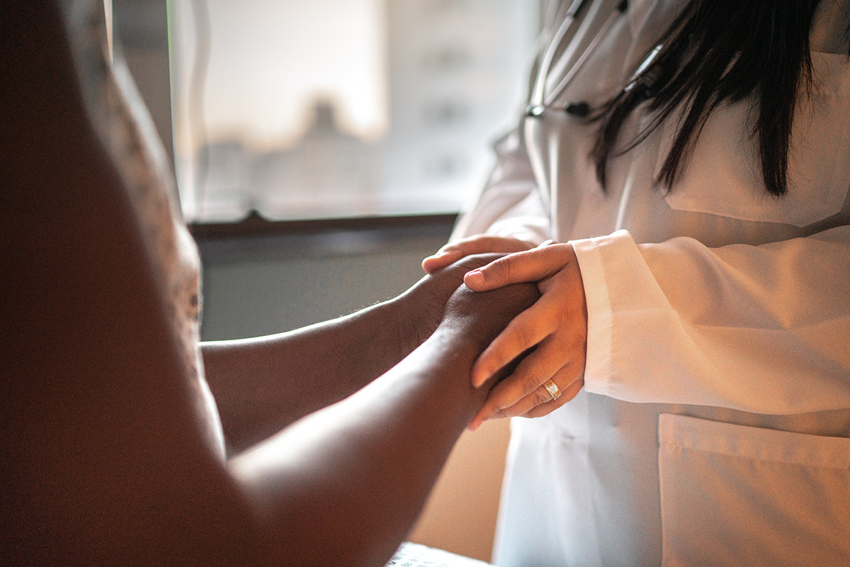 doctor holding hands with patient