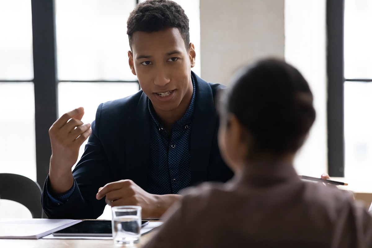 man talking with woman at a table