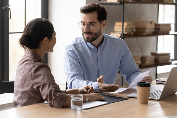 Father talking to young adult daughter at the table