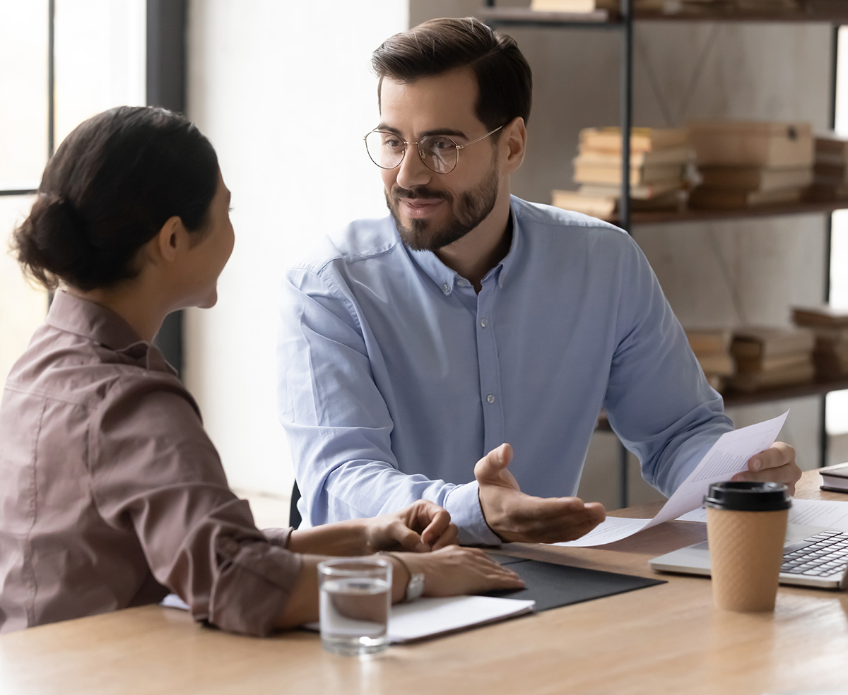 Father talking to young adult daughter at the table