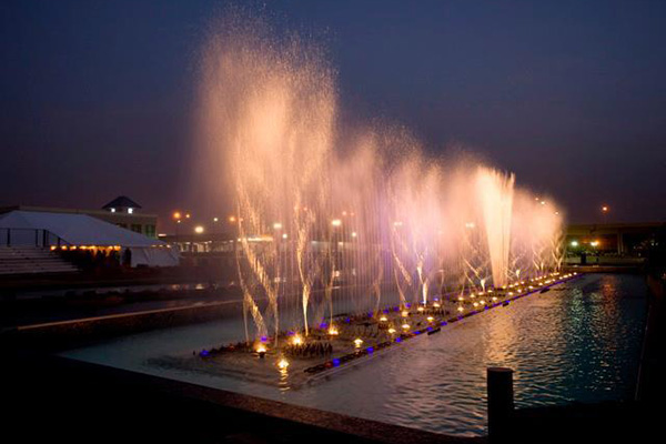 single file line of fountains blasting water into the air