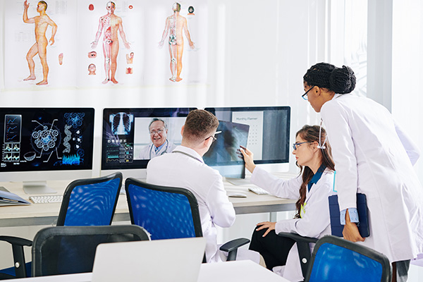 Doctors looking at x-rays on computers