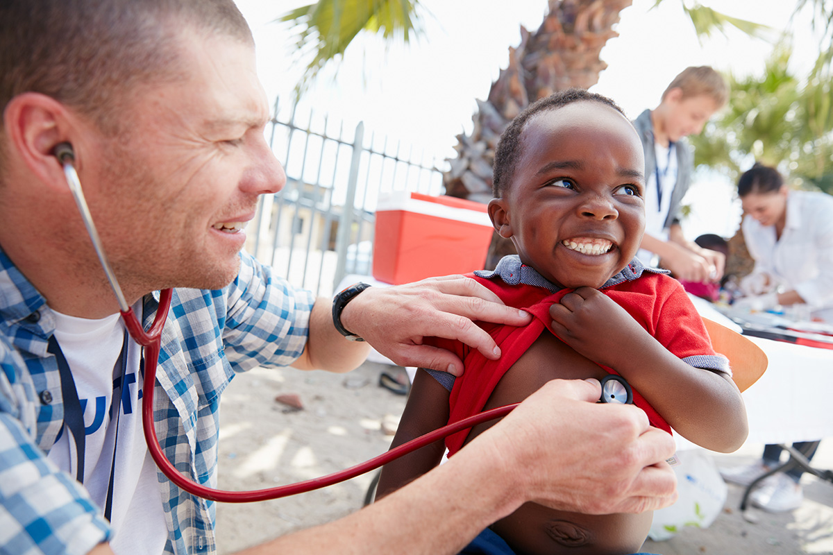 Males doctor listen to child's heart